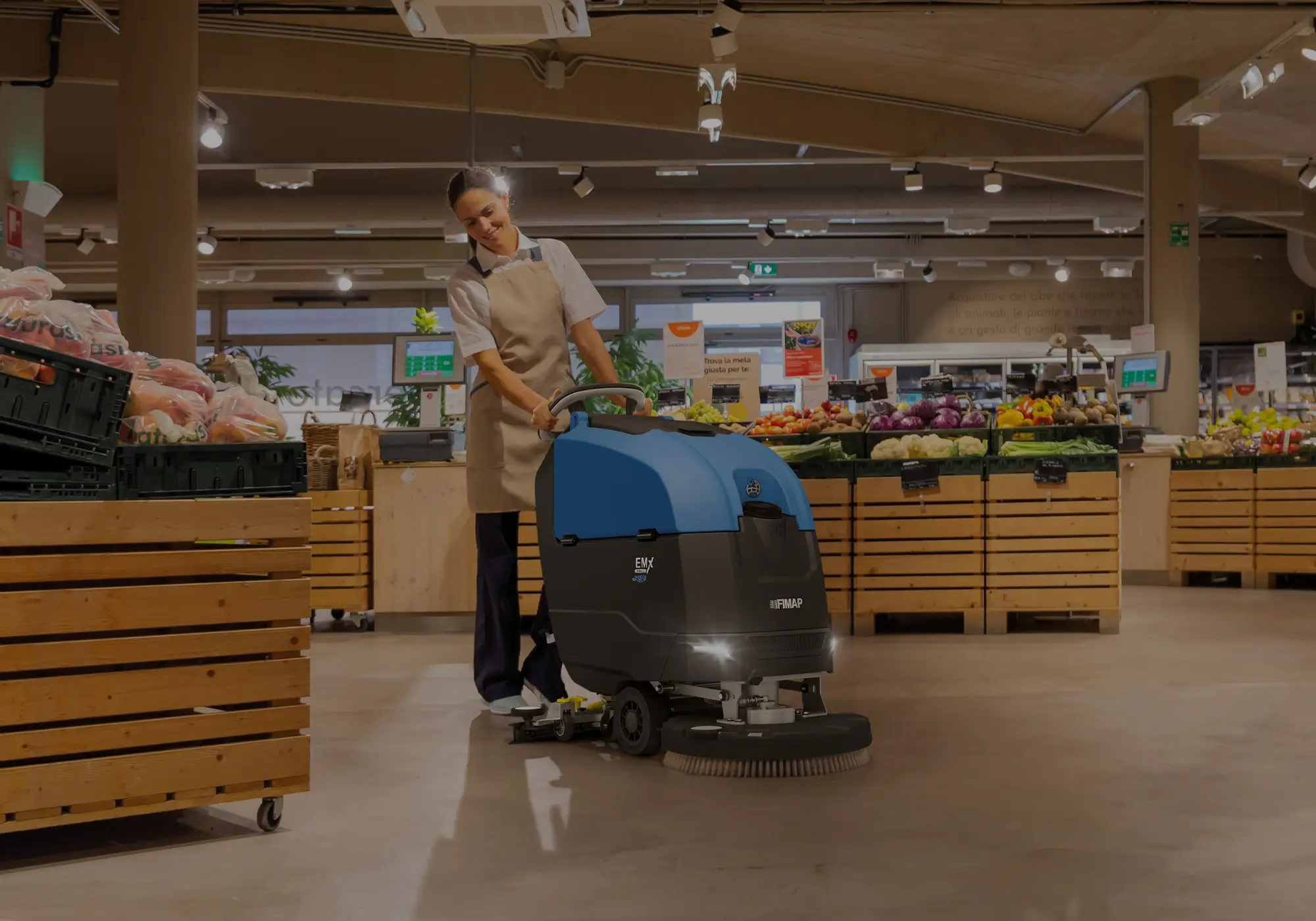 Fimap EMX walk-behind scrubber cleaning a supermarket floor