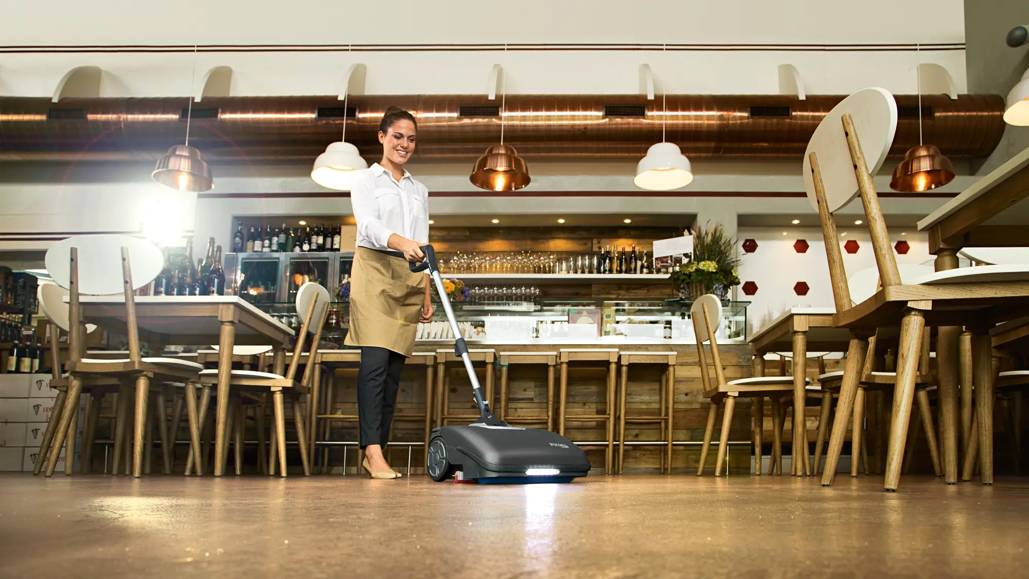 Fimap Fimop compact scrubber cleaning a café floor