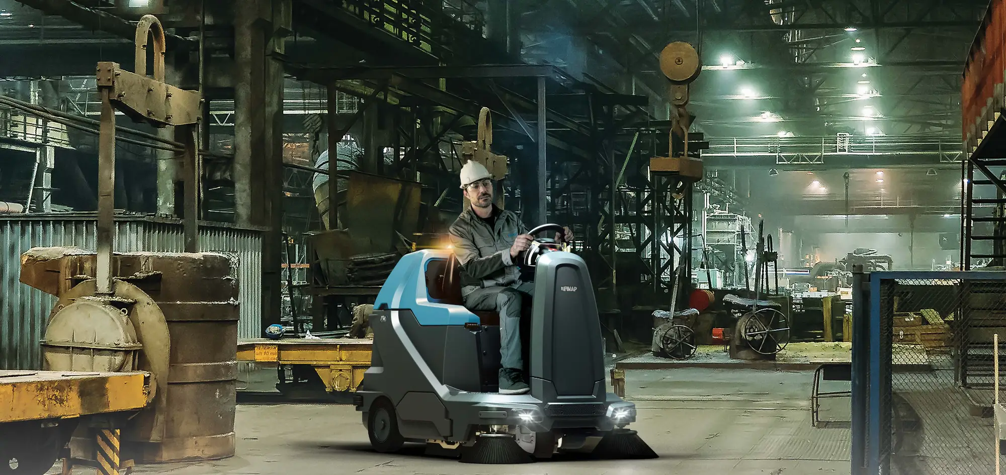 Fimap FSR ride-on sweeper driving through a foundry