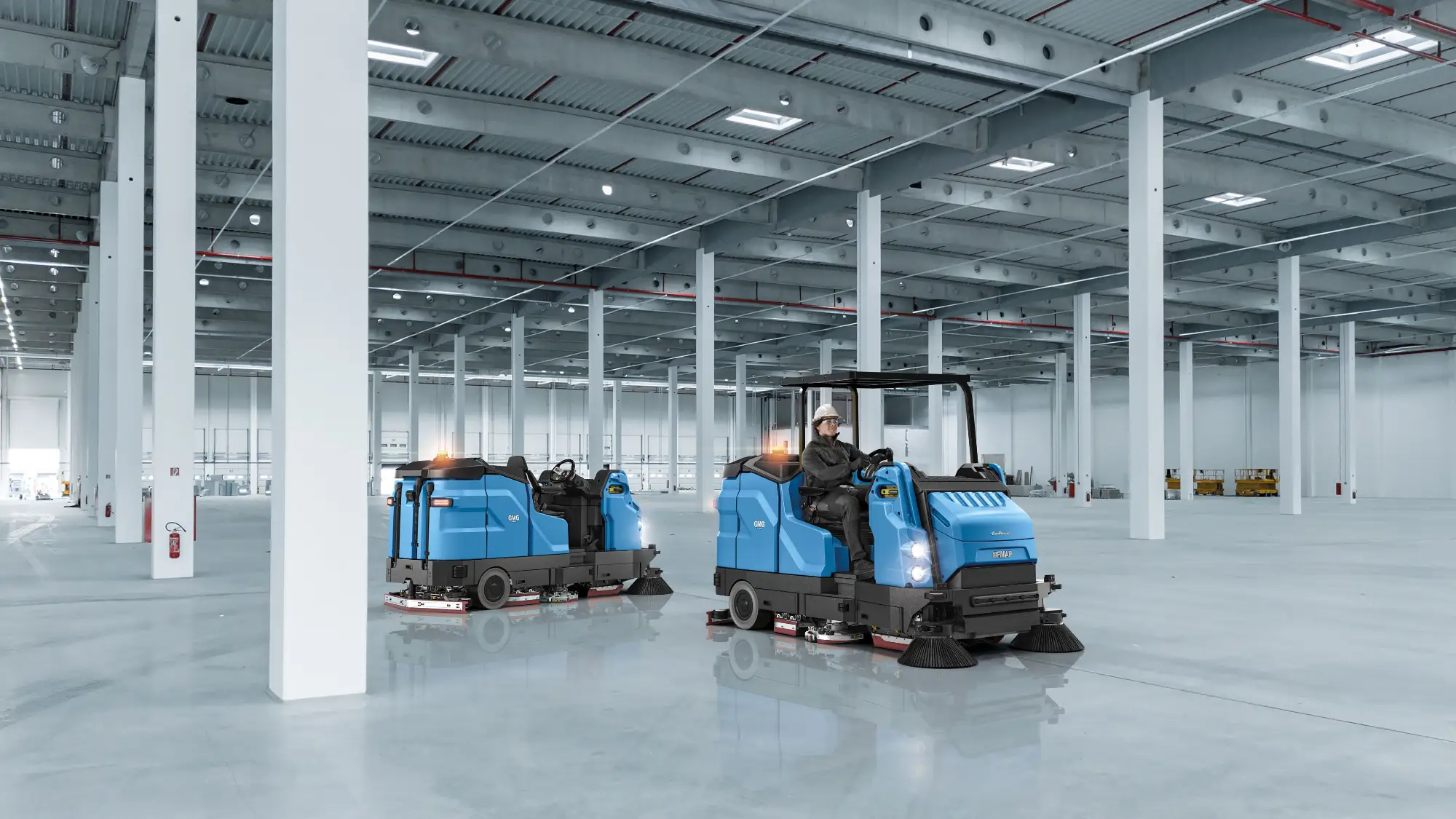 Two Fimap GMG ride-on machines in an empty distribution warehouse