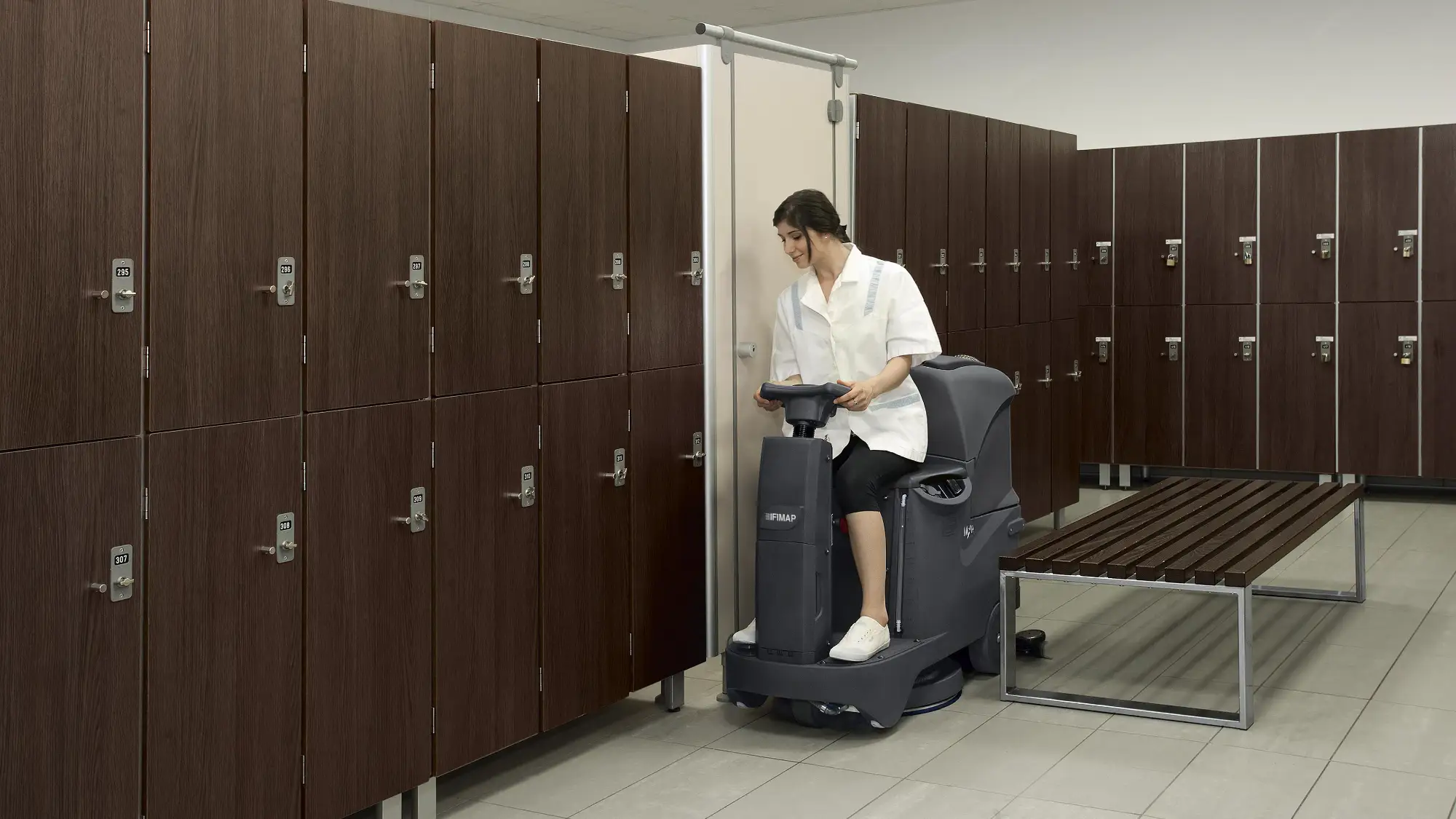 Fimap MxR compact ride-on scrubber cleaning a change room floor
